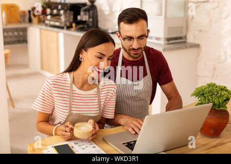 Before opening coffeehouse. Top view of just married couple feeling excited before opening coffeehouse Stock Photo