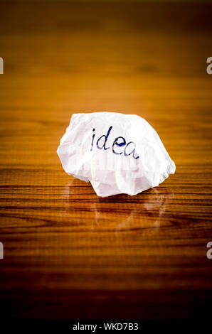 writing idea word on crumpled on wood background Stock Photo