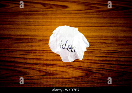 writing idea word on crumpled on wood background Stock Photo