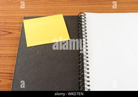 open notebook with post it on wood background Stock Photo