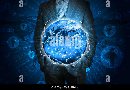 Businessman with glowing figures and Earth. Elements of this image are furnished by NASA Stock Photo