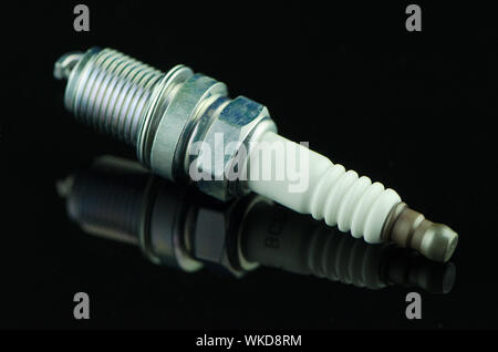 Spark-plug on black reflective background Stock Photo
