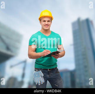 smiling man in helmet with clipboard Stock Photo