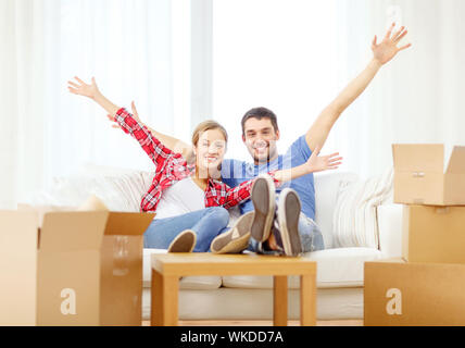 smiling couple relaxing on sofa in new home Stock Photo