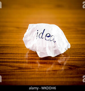 writing idea word on crumpled on wood background Stock Photo