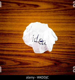 writing idea word on crumpled on wood background Stock Photo