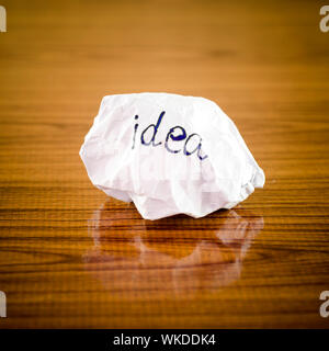 writing idea word on crumpled on wood background Stock Photo