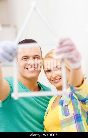 smiling couple with house from measuring tape Stock Photo