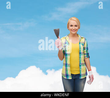 smiling female worker in gloves with spatula Stock Photo