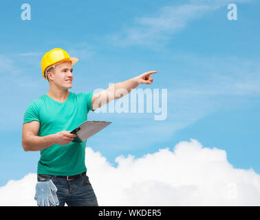 smiling man in helmet with clipboard Stock Photo