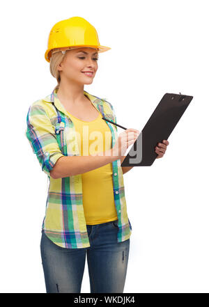 smiling woman in helmet with clipboard Stock Photo
