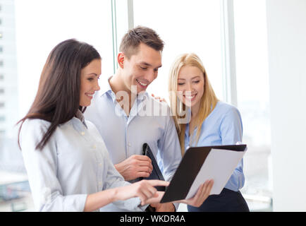 business team looking at clipboard Stock Photo