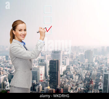 businesswoman writing something in air with marker Stock Photo