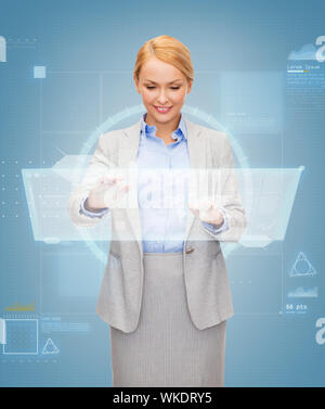smiling businesswoman working with virtual screen Stock Photo