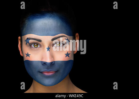 Composite image of honduras football fan in face paint against black Stock Photo