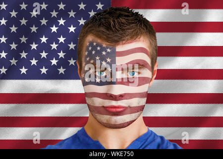 Composite image of serious young usa fan with facepaint against digitally generated american national flag Stock Photo