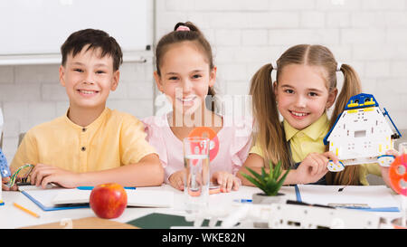 Stem education. Children building robots in classroom Stock Photo