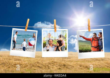 Composite image of instant photos hanging on a line against field and blue sky Stock Photo