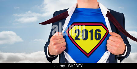 Composite image of businessman opening shirt in superhero style against bright sky Stock Photo