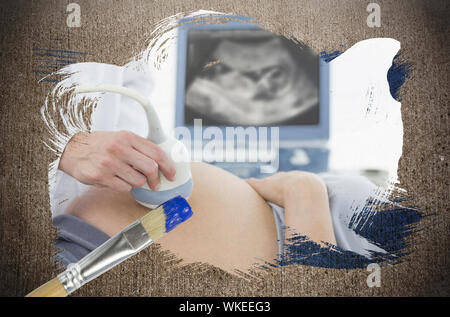 Composite image of pregnant woman getting an ultrasound with paintbrush dipped in blue against weathered surface Stock Photo