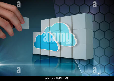 Hand building wall showing two blue clouds for cloud computing Stock Photo