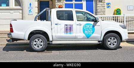 Bournemouth Christchurch & Poole council beach vehicle with ‘coast with the most’ slogan parked at BCP seafront management offices Dorset England UK Stock Photo