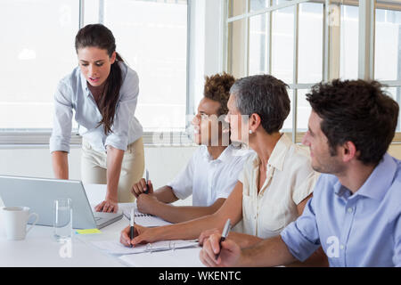 Business people using laptops and notebooks in meeting in the office Stock Photo