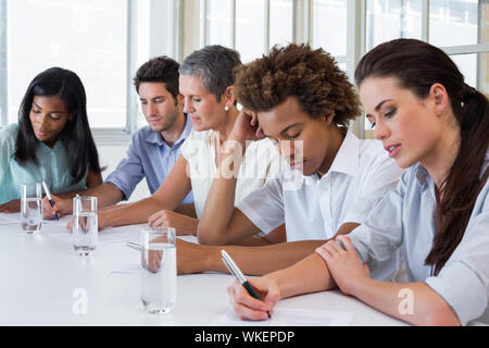 Business people taking down important notes in the office Stock Photo