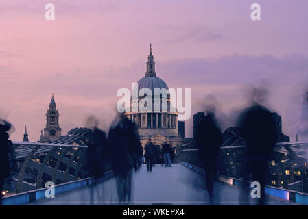Blurred Motion Of People On Millennium Bridge Leading Towards St Paul Cathedral At Dusk