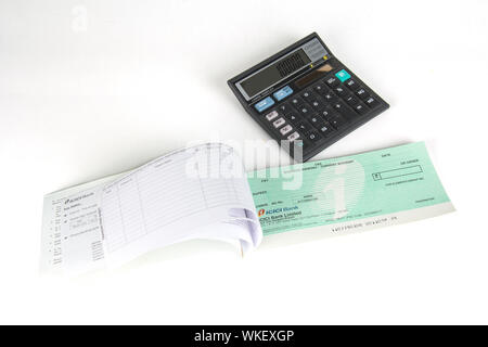 Close-up of an empty cheque book with calculator Stock Photo