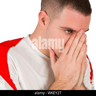 Disappointed football player looking down on white background Stock Photo