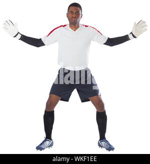 Goalkeeper in white ready to save on white background Stock Photo