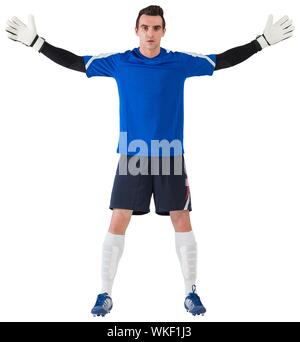 Goalkeeper in blue ready to save on white background Stock Photo