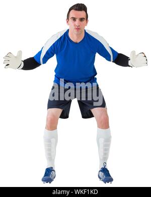 Goalkeeper in blue ready to save on white background Stock Photo