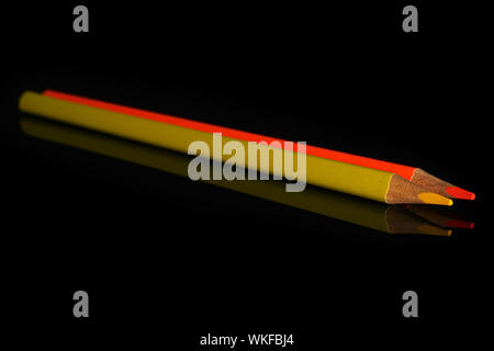 Group of two whole colored pencil isolated on black glass Stock Photo