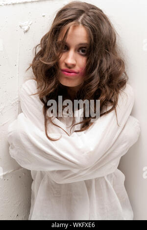 Young insane woman with straitjacket looking at camera close-up portrait Stock Photo
