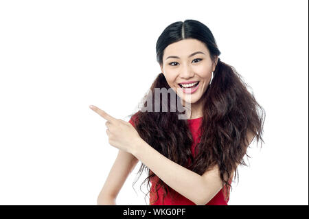 Pretty girl pointing towards something Stock Photo