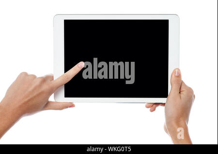 Womans finger pointing on tablet screen Stock Photo