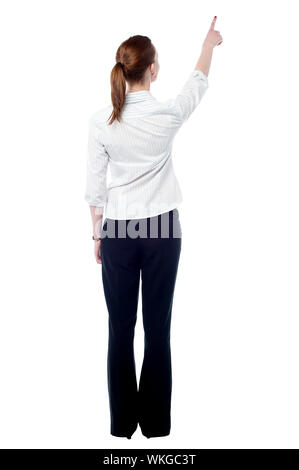 Rear view of woman pointing empty space Stock Photo