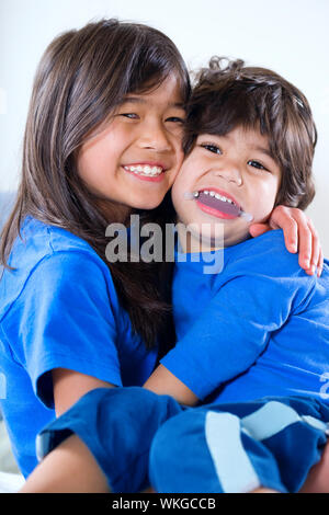 Big sister taking care of her disabled little brother Stock Photo