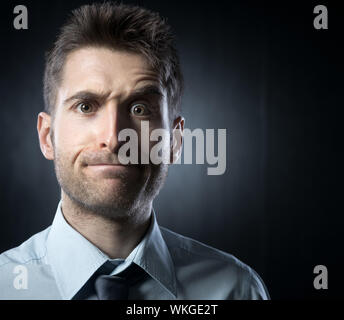 Young businessman: confused expression with raised eyebrow. Stock Photo