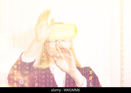 Woman in VR glasses, hands control, binary code Stock Photo