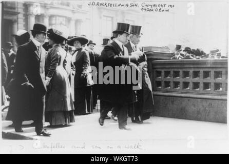 John Davison Rockefeller, full-length portrait, walking, facing right, with his son Stock Photo