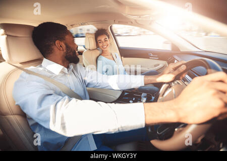 Test drive. Happy couple talking in car Stock Photo