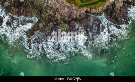 An aerial view of waves crashing up the Cornish coast. Stock Photo