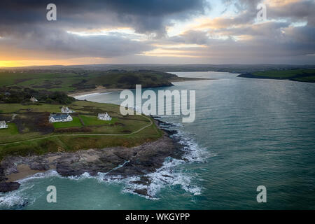 An aerial view of Daymer Bay at sunrise with clouds gathering. Daymer in the foreground and Brea Hill and Padstow off in the distance. Stock Photo