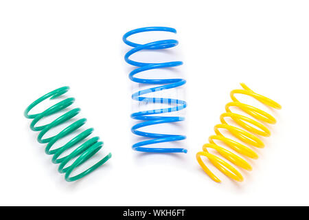 Yellow, Green and Blue plastic Spring Toy or Spirals isolated on white Background Stock Photo