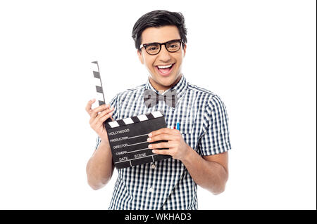 Young man holding movie clapboard isolated on white Stock Photo