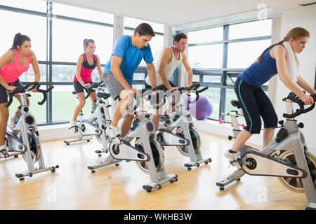 Determined five people working out at spinning class in gym Stock Photo ...
