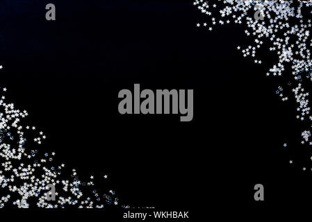 Star shaped silver sequins background. Copy space. Stock Photo